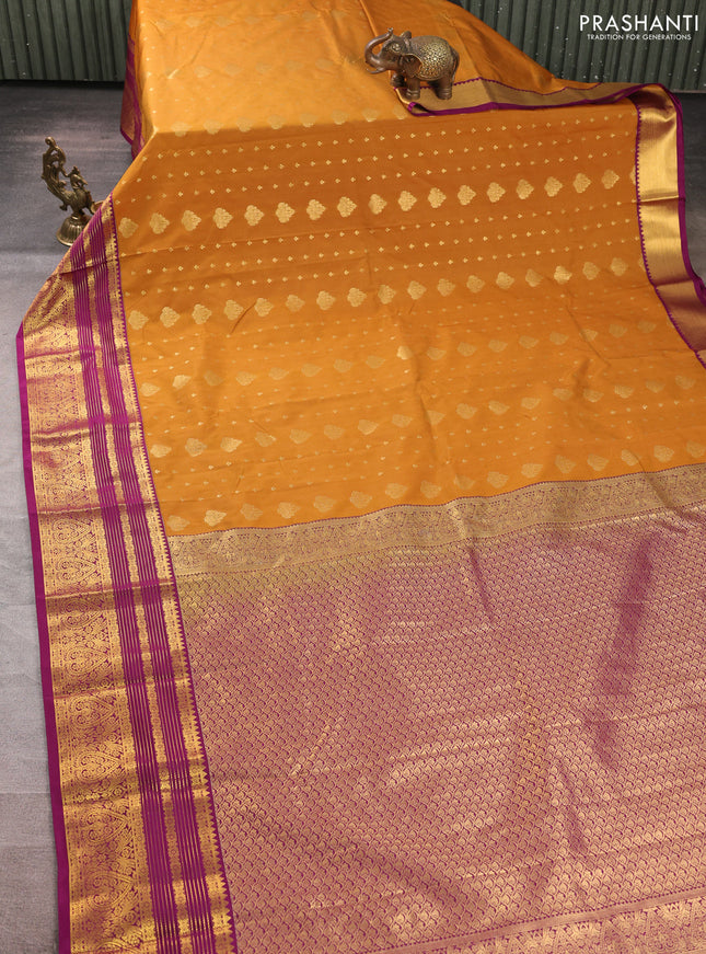Semi kanchipuram silk saree dark mustard and purple with allover zari woven buttas and zari woven korvai border