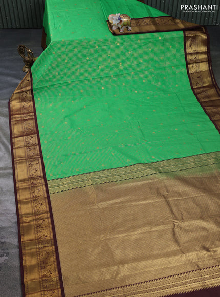 Semi kanchipuram silk saree green and deep maroon with allover small zari checks & buttas and zari woven korvai border