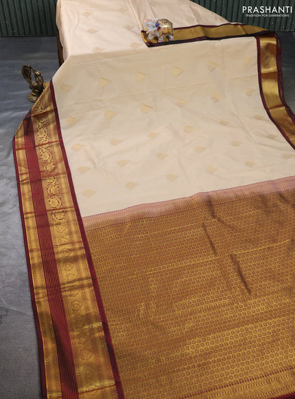 Semi kanchipuram silk saree cream and deep maroon with allover zari weaves & buttas and zari woven border