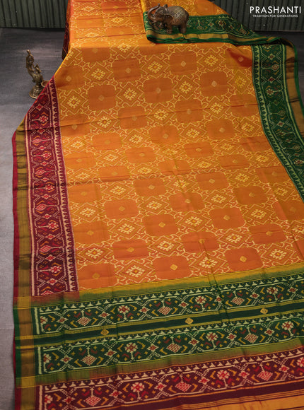 Rajkot patola silk saree dual shade of dark mustard and maroon bottle green with allover ikat weaves & zari buttas and ganga jamuna border