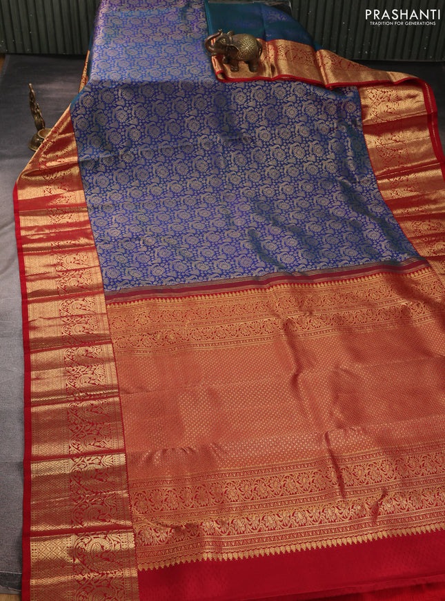 Pure kanchipuram silk saree dual shade of bluish green and red with allover zari woven brocade weaves and long zari woven border