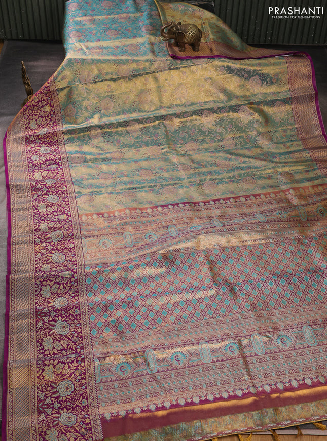 Pure kanchipuram tissue silk saree dual shade of teal blue and purple with allover zari woven brocade weaves and long zari woven minakari border