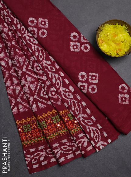 Batik cotton saree wine shade with allover batik prints and embroidery mirror work border
