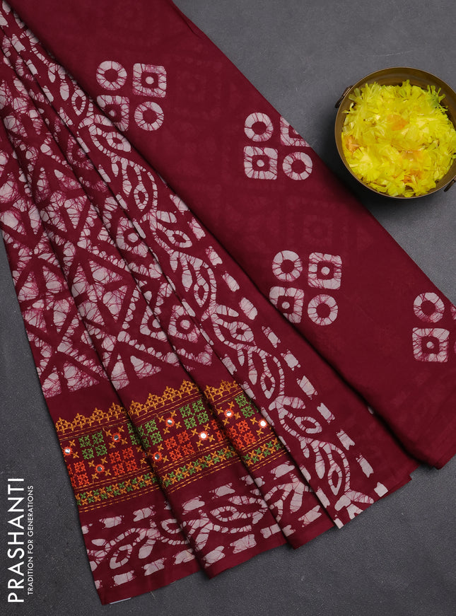 Batik cotton saree wine shade with allover batik prints and embroidery mirror work border