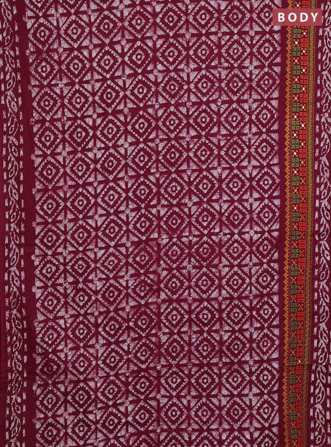 Batik cotton saree wine shade with allover batik prints and embroidery mirror work border