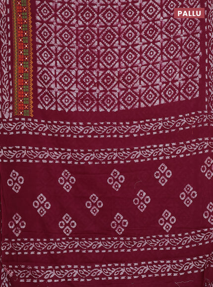 Batik cotton saree wine shade with allover batik prints and embroidery mirror work border