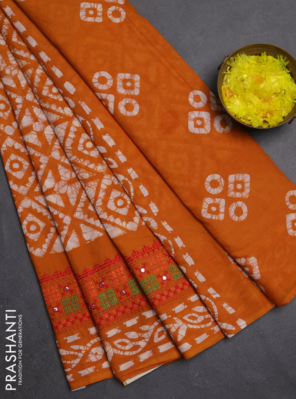 Batik cotton saree mustard yellow with allover batik prints and embroidery mirror work border