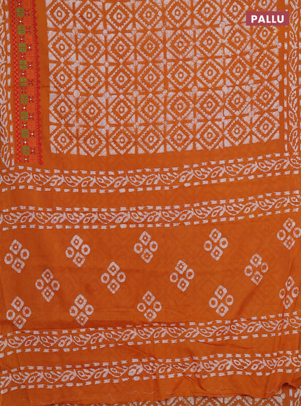 Batik cotton saree mustard yellow with allover batik prints and embroidery mirror work border