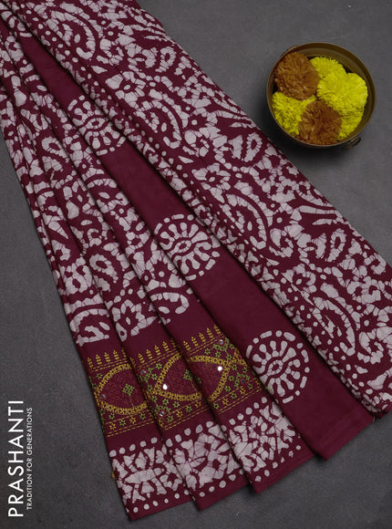 Batik cotton saree wine shade with allover batik prints and embroidery mirror work border