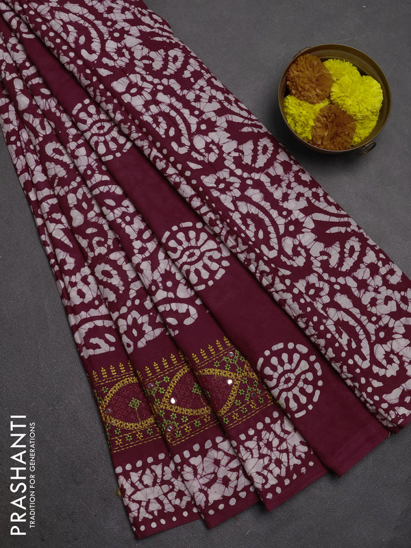 Batik cotton saree wine shade with allover batik prints and embroidery mirror work border