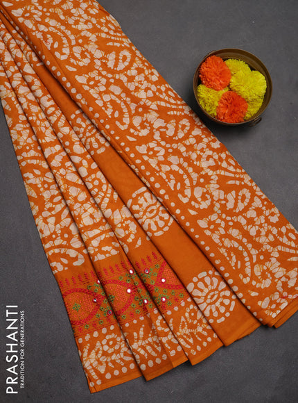 Batik cotton saree mustard yellow with allover batik prints and embroidery mirror work border