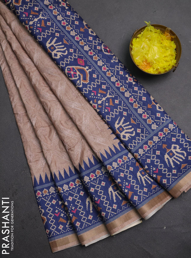 Art tussar saree beige and navy blue with allover embroidery work and patola printed border