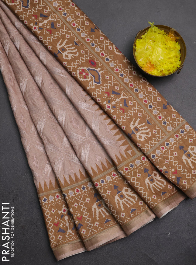 Art tussar saree beige and dark mustard with allover embroidery work and patola printed border