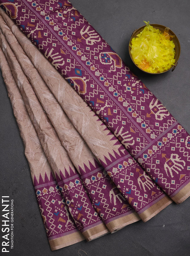 Art tussar saree beige and purple with allover embroidery work and patola printed border