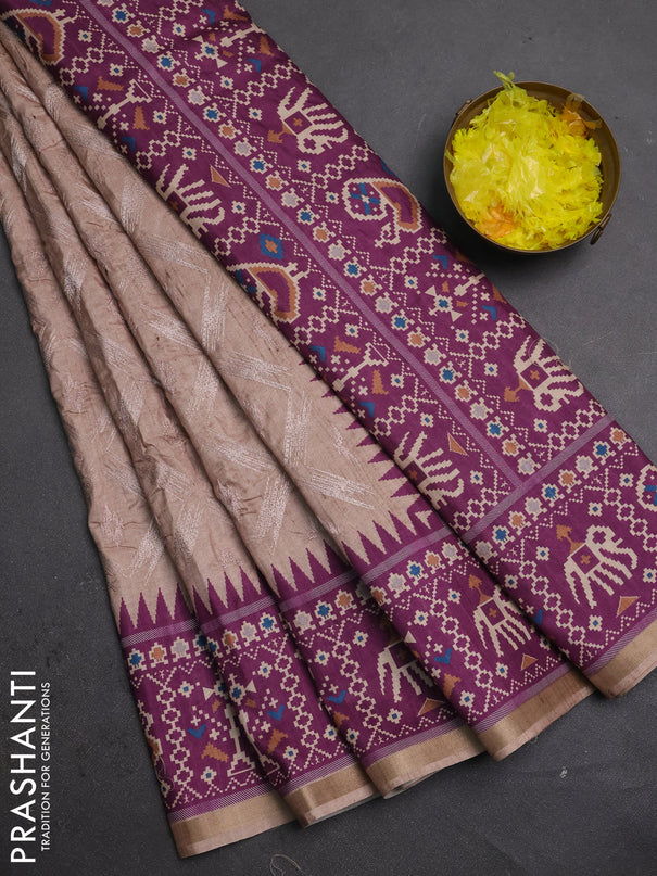 Art tussar saree beige and purple with allover embroidery work and patola printed border