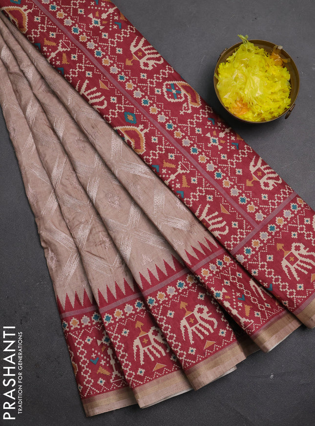 Art tussar saree beige and maroon with allover embroidery work and patola printed border