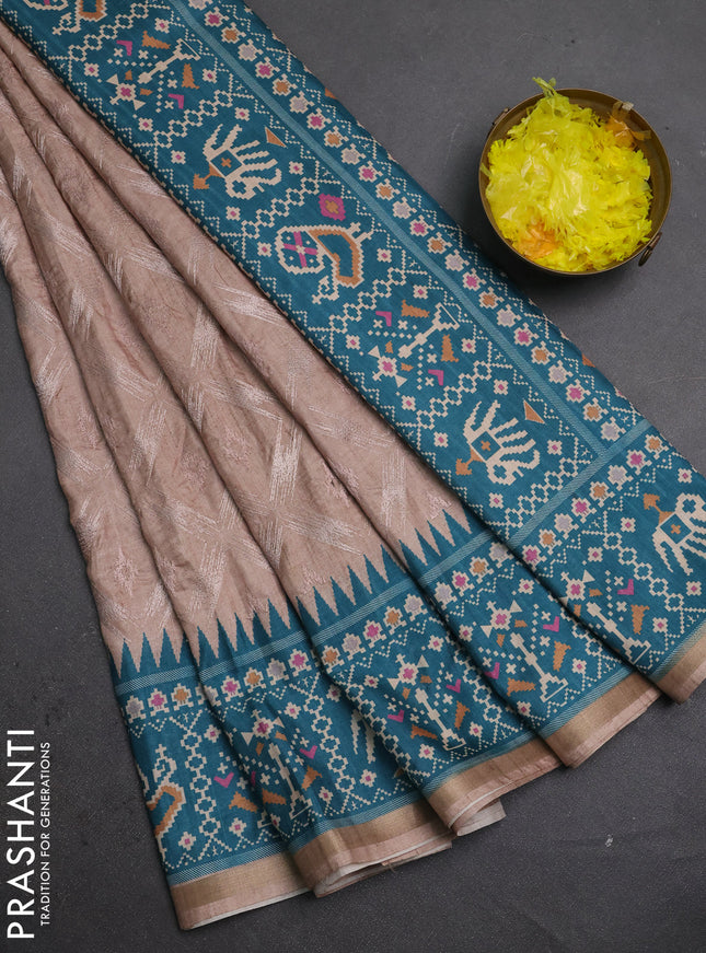 Art tussar saree beige and teal green with allover embroidery work and patola printed border