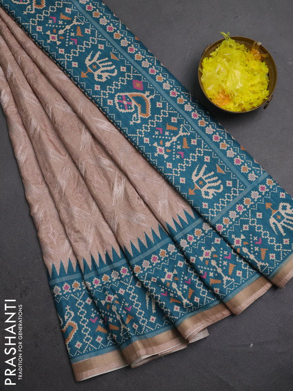 Art tussar saree beige and teal green with allover embroidery work and patola printed border