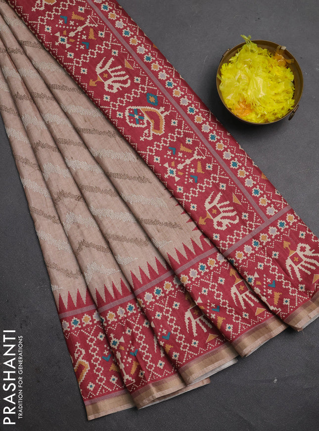 Art tussar saree beige and maroon with allover embroidery work and patola printed border