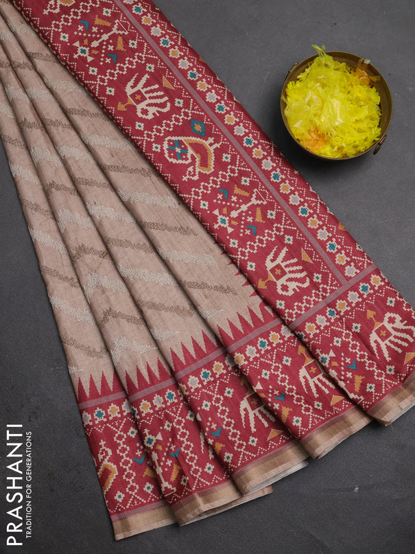 Art tussar saree beige and maroon with allover embroidery work and patola printed border