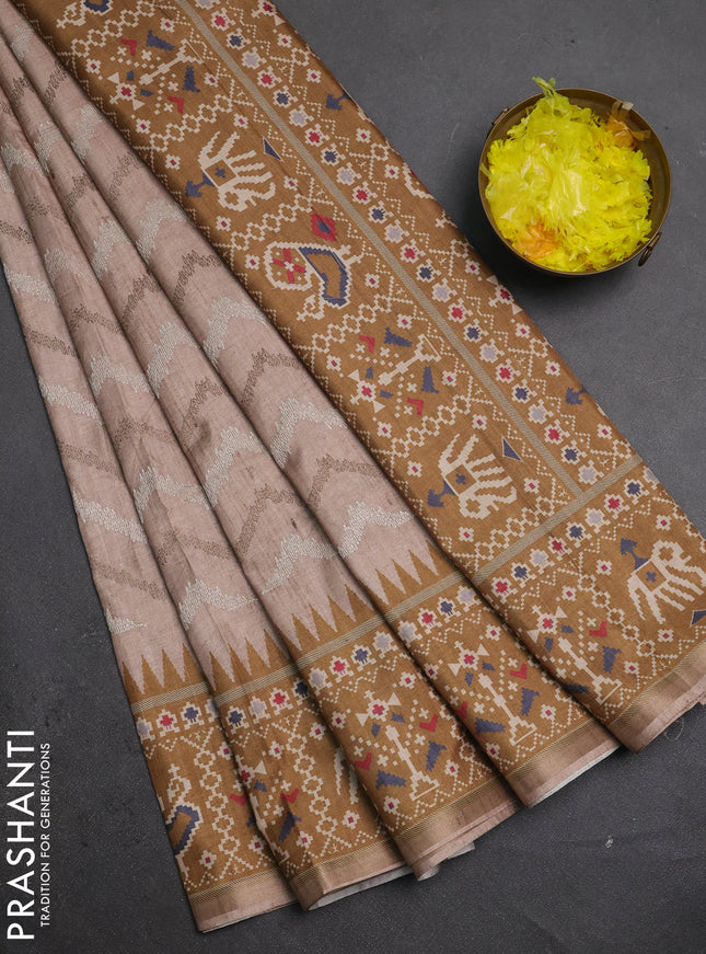 Art tussar saree beige and dark mustard with allover embroidery work and patola printed border