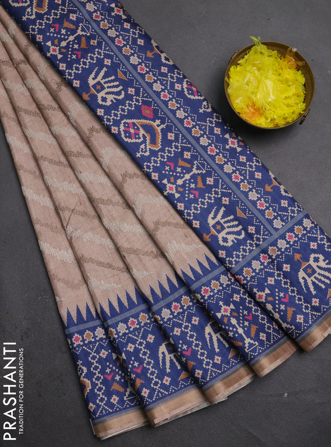 Art tussar saree beige and blue with allover embroidery work and patola printed border