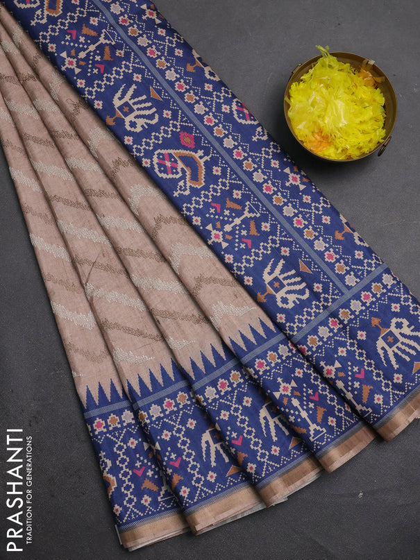 Art tussar saree beige and blue with allover embroidery work and patola printed border