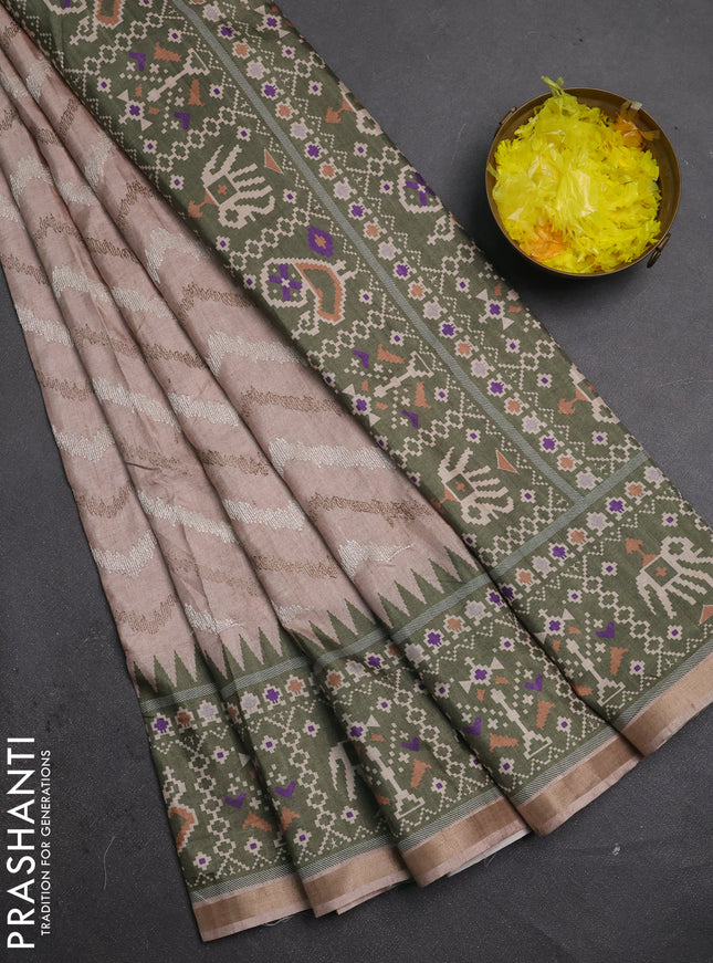 Art tussar saree beige and green with allover embroidery work and patola printed border