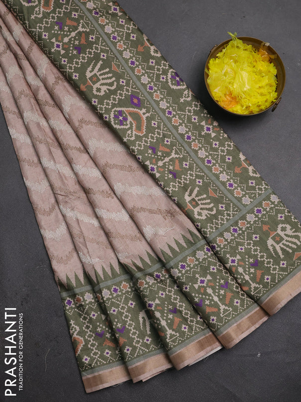 Art tussar saree beige and green with allover embroidery work and patola printed border