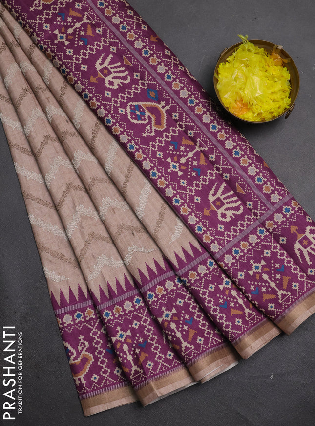 Art tussar saree beige and purple with allover embroidery work and patola printed border