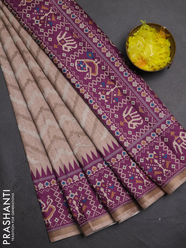 Art tussar saree beige and purple with allover embroidery work and patola printed border