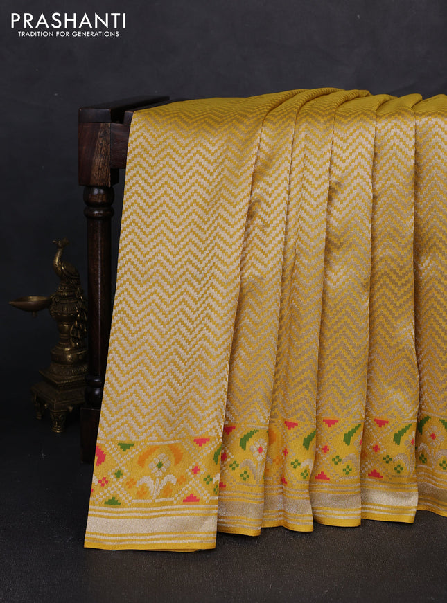 Banarasi raw silk saree yellow with allover silver zari woven brocade weaves and paithani style border