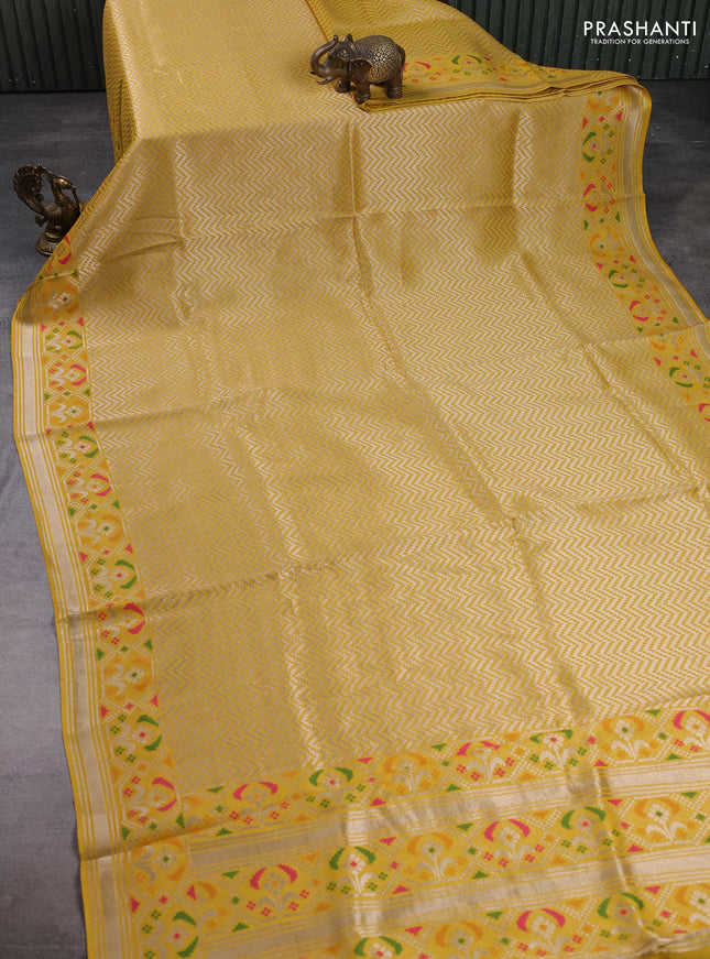 Banarasi raw silk saree yellow with allover silver zari woven brocade weaves and paithani style border
