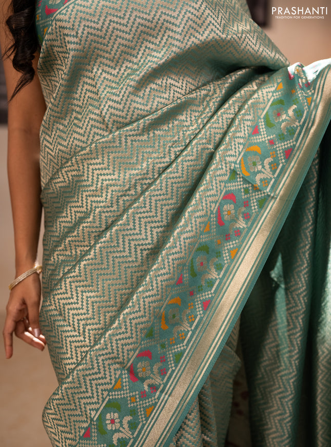 Banarasi raw silk saree teal green with allover silver zari woven brocade weaves and paithani style border