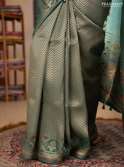 Banarasi raw silk saree teal green with allover silver zari woven brocade weaves and paithani style border