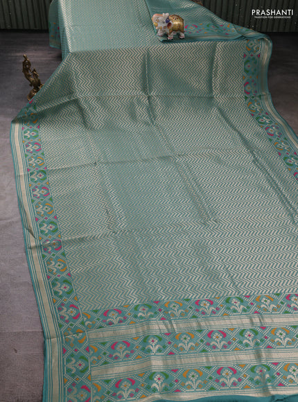 Banarasi raw silk saree teal green with allover silver zari woven brocade weaves and paithani style border