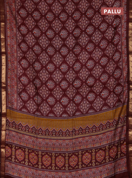 Semi maheshwari cotton saree maroon with allover ajrakh prints and zari woven muniya style border