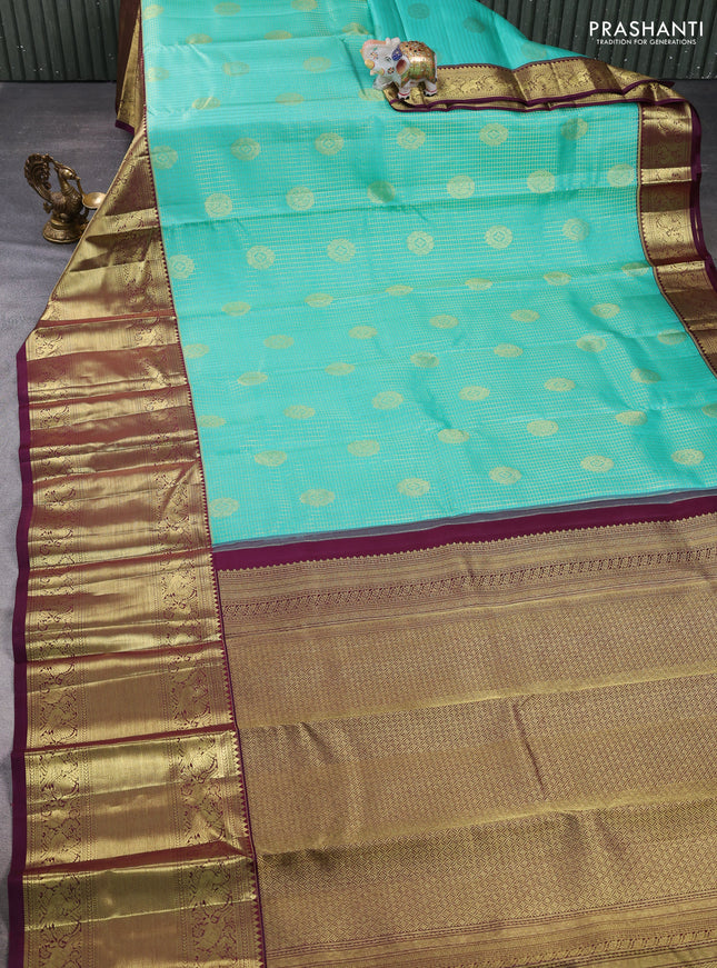 Pure kanchipuram silk saree teal green and wine shade with allover small zari checks & buttas and long zari woven border