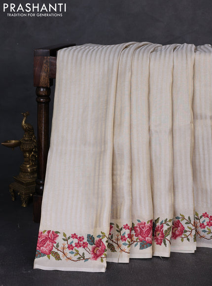Tissue saree off white with allover zari stripe pattern and embroidery border