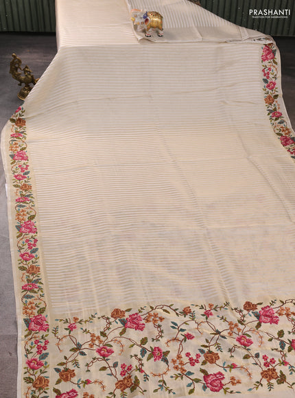 Tissue saree off white with allover zari stripe pattern and embroidery border