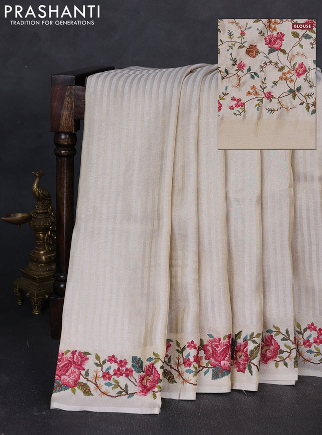 Tissue saree off white with allover zari stripe pattern and embroidery border