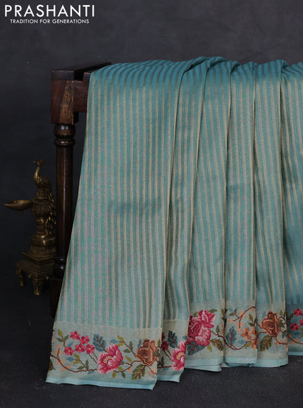Tissue saree teal blue with allover zari stripe pattern and embroidery border