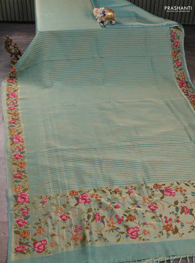 Tissue saree teal blue with allover zari stripe pattern and embroidery border