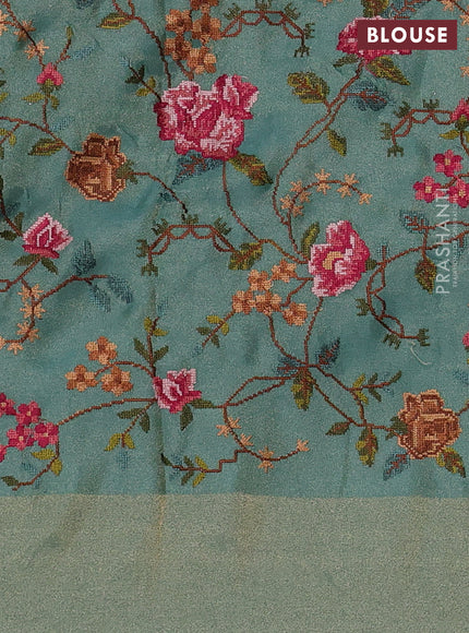 Tissue saree teal blue with allover zari stripe pattern and embroidery border