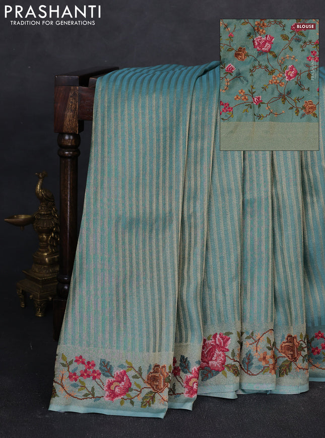Tissue saree teal blue with allover zari stripe pattern and embroidery border