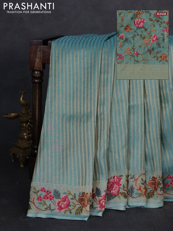 Tissue saree teal blue with allover zari stripe pattern and embroidery border