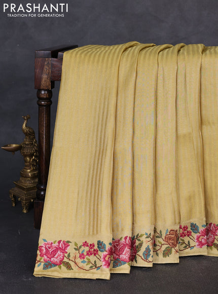Tissue saree yellow with allover zari stripe pattern and embroidery border