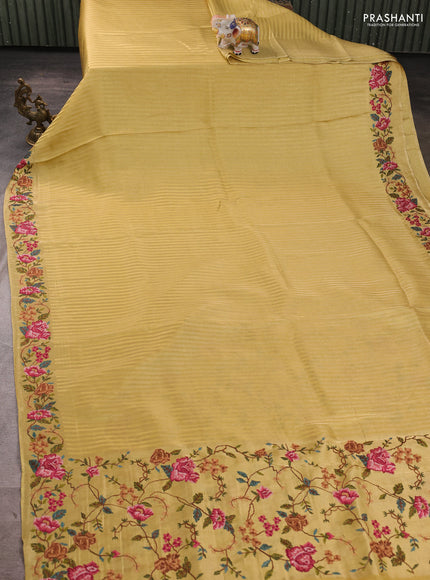 Tissue saree yellow with allover zari stripe pattern and embroidery border