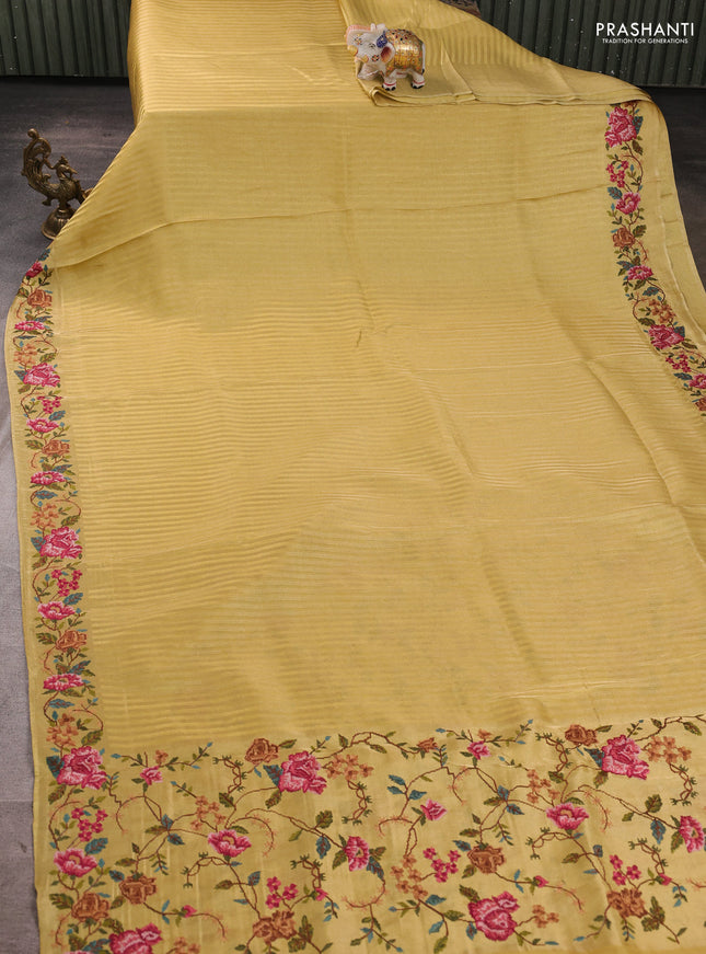 Tissue saree yellow with allover zari stripe pattern and embroidery border