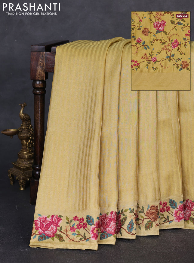 Tissue saree yellow with allover zari stripe pattern and embroidery border